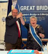 Mrs. Storage and Mr. Elston used Don Ferguson’s U.S. Naval Academy saber to cut the anniversary cake