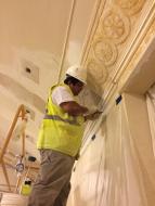Sandro Camargo, a craftsman with Hayles &amp; Howe, working on the Rosettes
