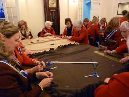 The National Board of Management worked together together to tie the edges of the fleece blankets for the Veterans