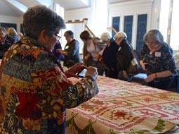 “Eye Opening” symposium participants took a break from scholarly papers to get up close  with other quilts from the DAR Museum collection, one of the largest in the United States.