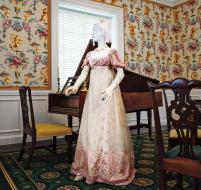 The delicacy of sheer silk net and gauze dresses fit the aesthetic of the light, flowing styles of the turn of the century. The gauze has been woven with a larger scale floral design for the lower part of the skirt.